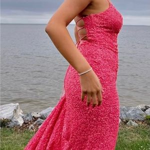 Hot pink sequened prom dress with spaghetti straps and cross cross back.